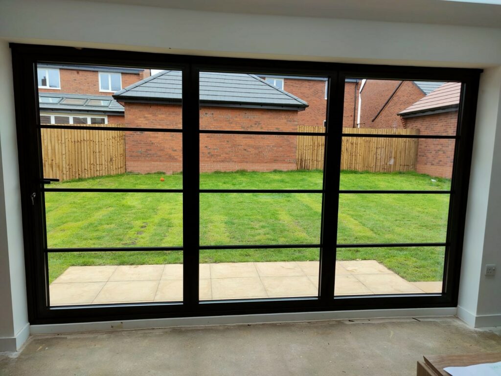 Black Schuco steel look bifold doors in a new extension