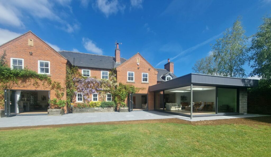 back of a large modern house with new patio doors