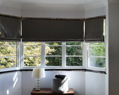 white bay window viewed from inside the room