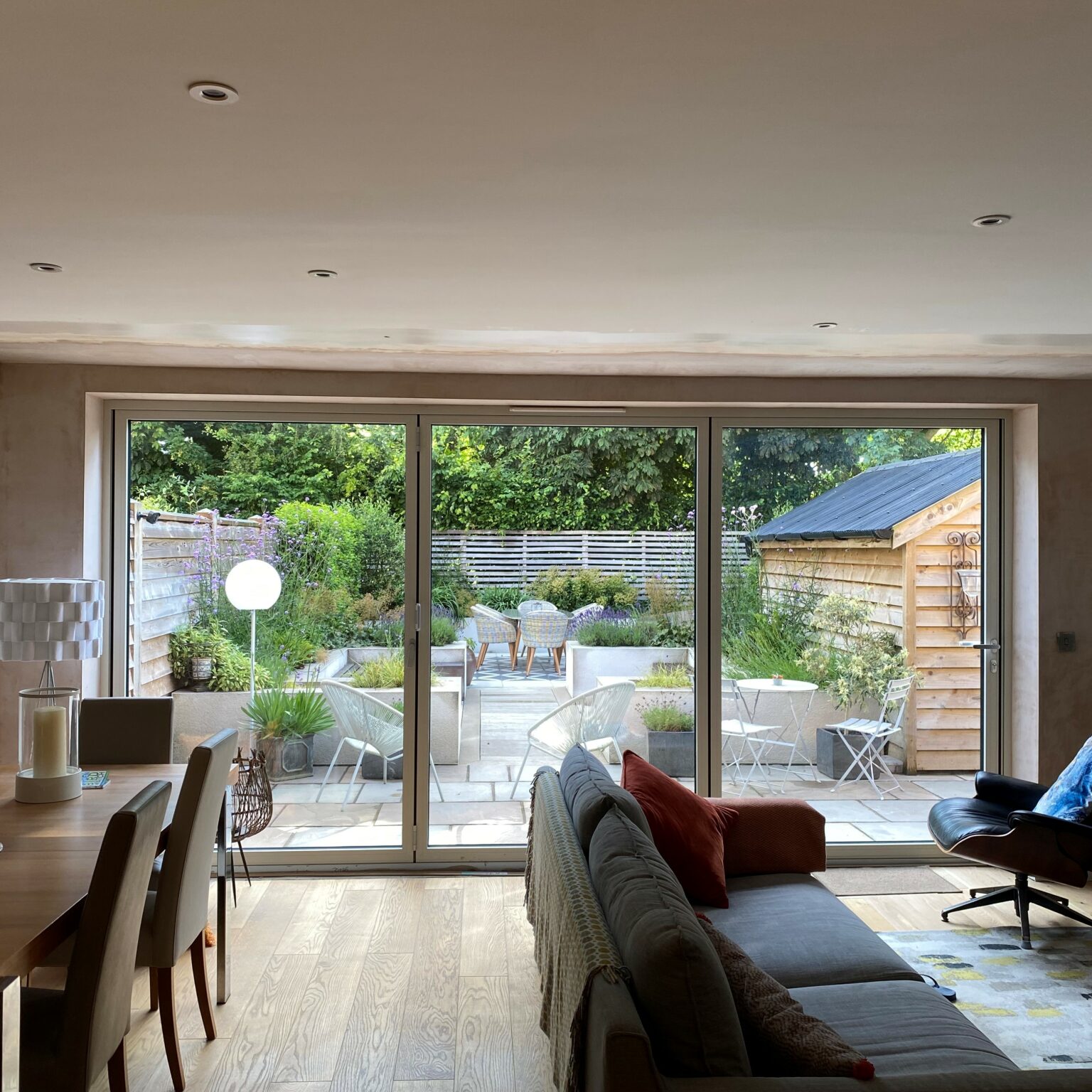 Schuco ASS70 bifolding door fully open with garden views