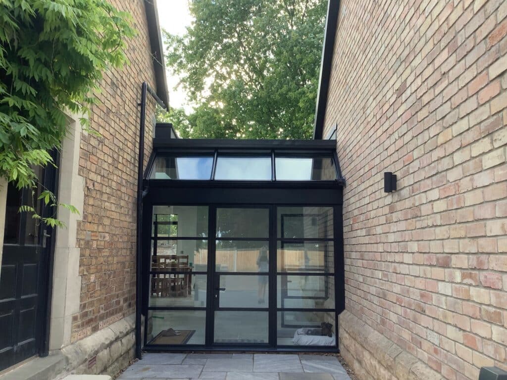 glazed link between two rooms from steel look doors in aluminium 
