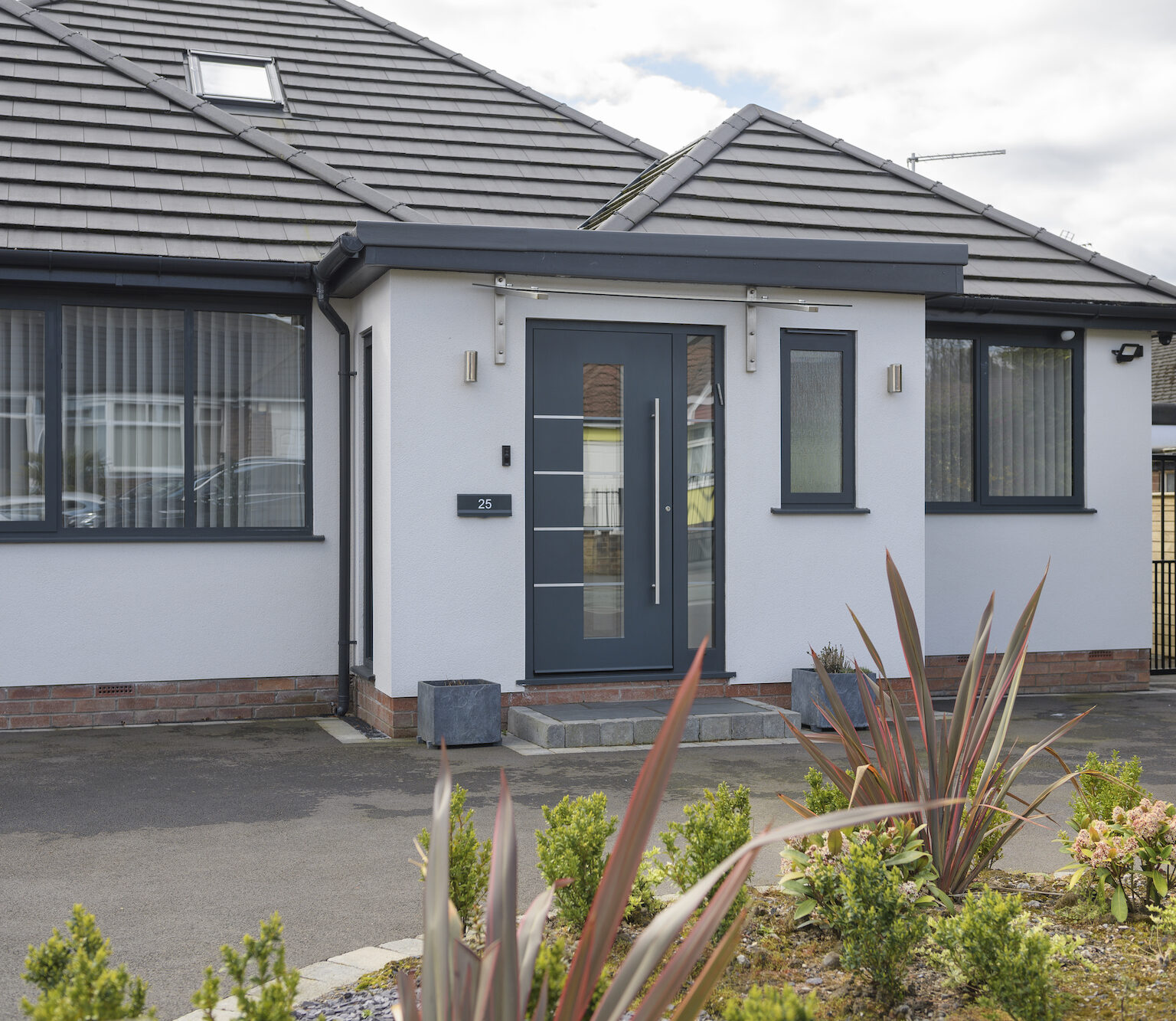 Spitfire front doors in a modern new build house with white render