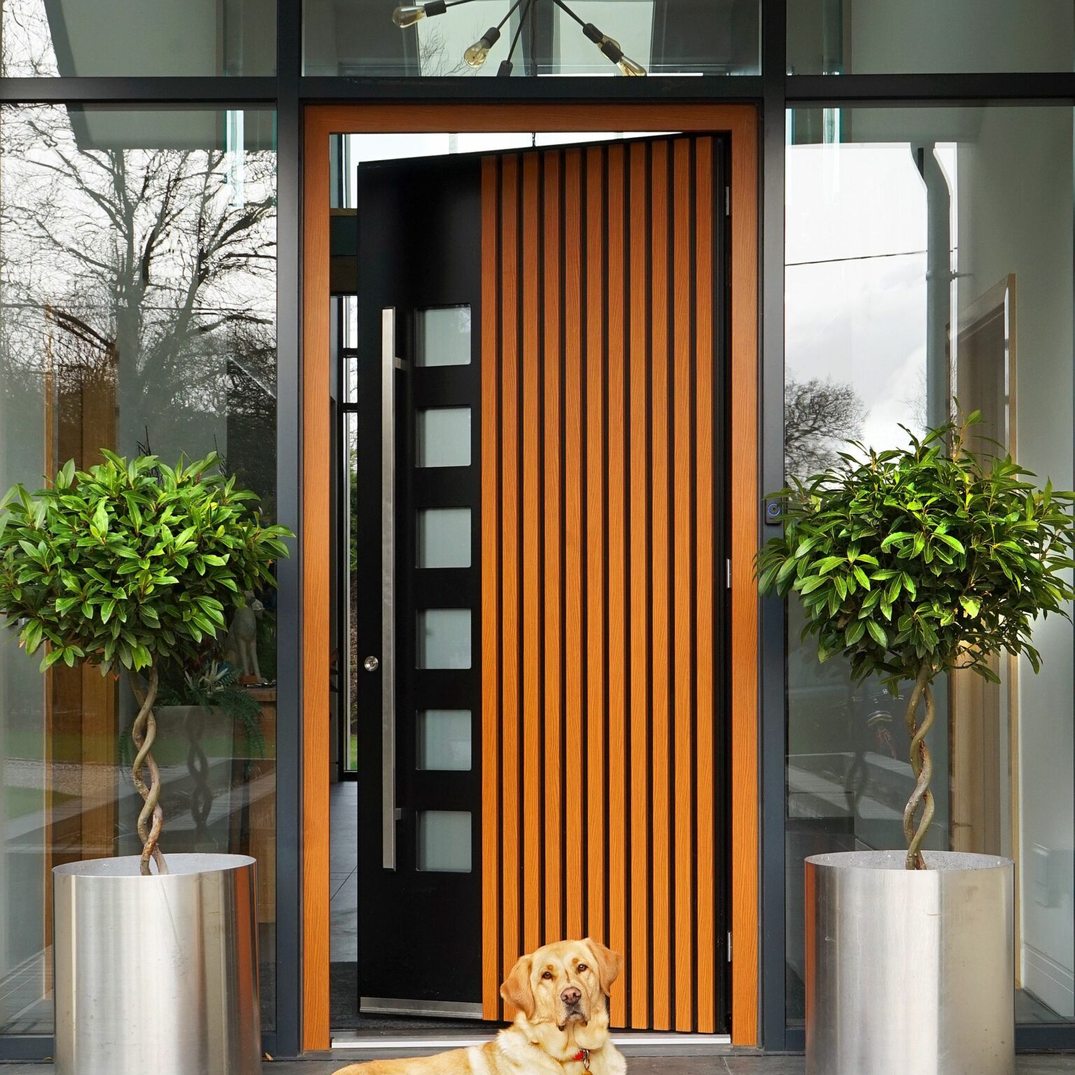 spitfire front doors showing a wood an metal door partially open in a porch